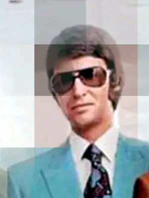 Man in a teal suit and sunglasses