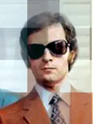 Man in a rust suit and sunglasses